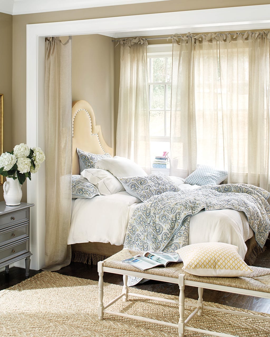 Canopy-inspired bed created with sheer linen drapery panels