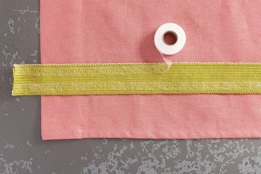 Place iron on tape along the green trim, working in about one foot sections