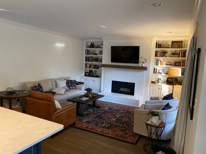 Built in bookshelves with brick fireplace in open concept room