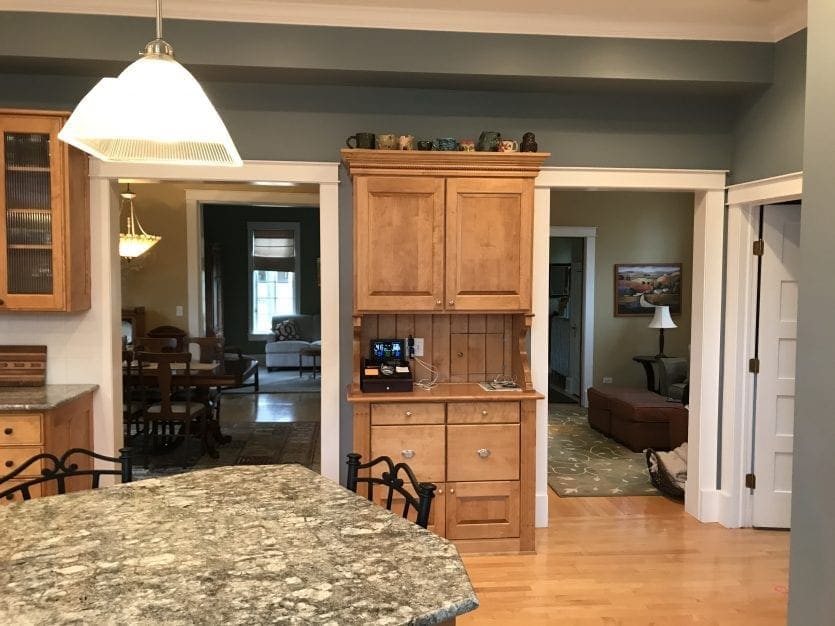 Kitchen with wood cabinets and sage green walls