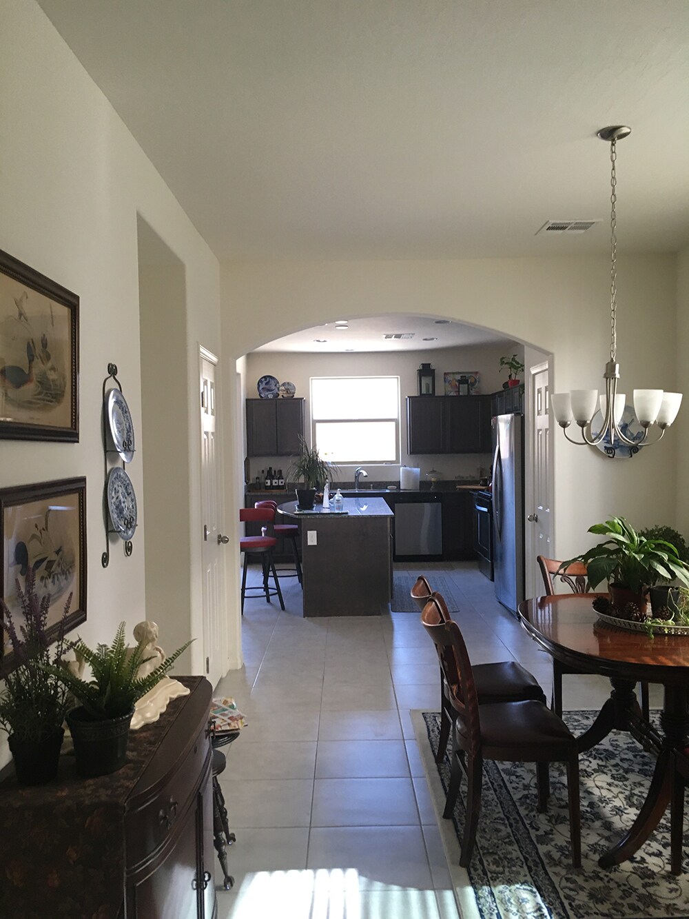 Kitchen with center window and dark cabinetry