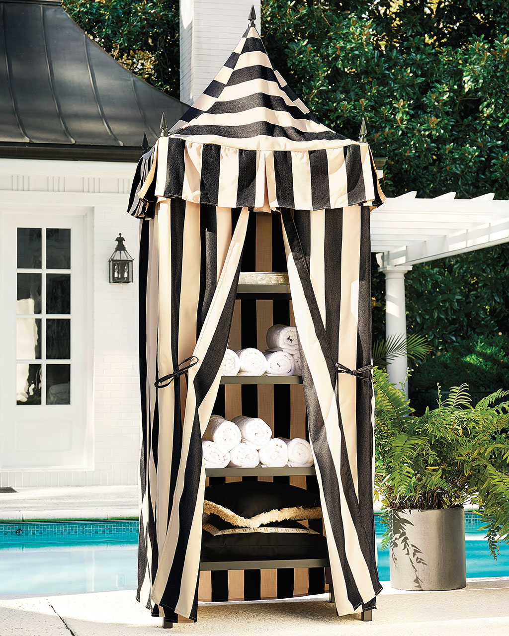 A striped towel cabana stores towels, cushions, and pillows out of site when not in use